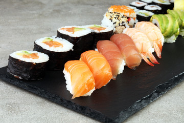 close up of sashimi sushi set with chopsticks and soy - sushi roll with salmon and sushi roll with smoked eel, selective focus.