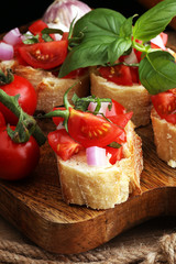 Fototapeta na wymiar Bruschetta with tomatoes, herbs and oil on toasted garlic cheese bread toasted with chopped tomatoe