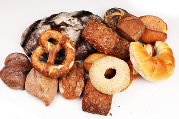 Different kinds of bread rolls on white board from above. Kitchen or bakery poster design.