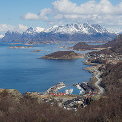 View near Bod&oslash;, Norway. Fisherman's houses, harbor, fjords and snowy mountains in the background
