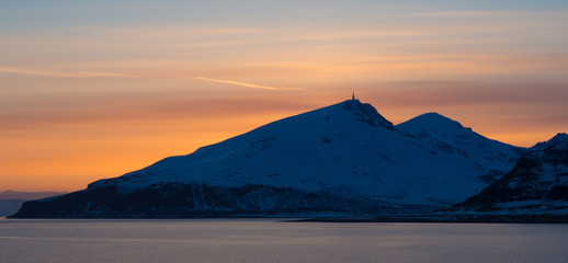 Mountain view at sunset near Tromsø, Norway. Seen from the ocean.
