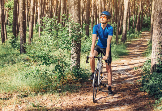 Young bicyclist riding in the forest