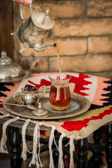 Tea set in oriental style in pear shaped glass with vintage kettle and dates fruit