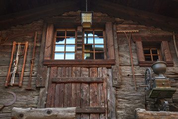 Facade of a building in Zermatt, Switzerland with various objects hanging on the wall.
