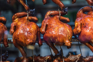 Closeup shot on roast chicken hanging in a hawker stall