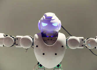 The head and torso of the robot with blue luminous eyes