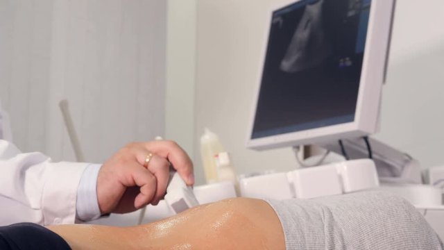 Close up of the doctor making the ultrasound examination of the abdominal cavity
