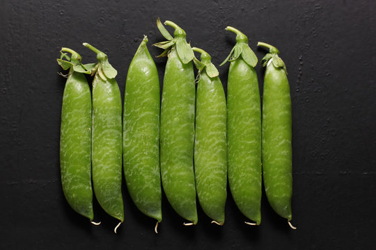 pods of pea on black background