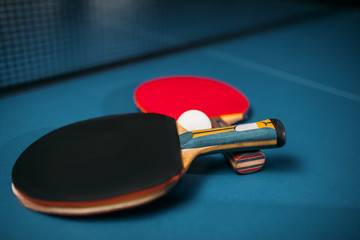 Tennis rackets and ball on the table, game concept