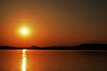 Fototapeta premium Sunset with sea and mountains