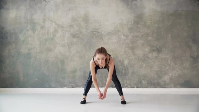 Young Beautiful Fit Woman Make Stretching Exercises To Worm Up And Tone Up Body For Dance Workshop