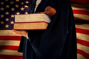 Composite image of lawyer holding scales of justice