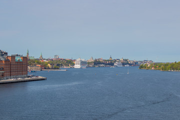 Fototapeta premium Southern Stockholm seen from the fjord in southwestern direction. The cruise ships are docked at Stadsgarden harbour.