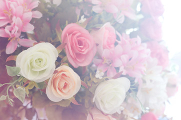 Artificial roses flower bouquet and soft focus background with light flare