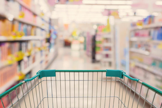 Shopping cart view with Supermarket aisle blurred background