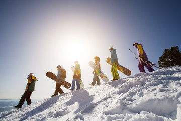 Group of people snowboarders and skiers on mountain sunset. Winter Sport outdoor © Annatamila