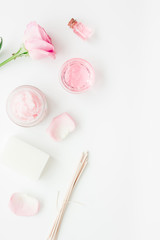 spa set with rose flowers and cosmetic for body on white desk background top view mockup