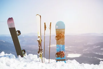 Rolgordijnen Ski and snowboard on the mountain top in snow © Annatamila