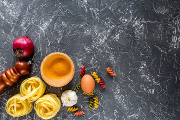 Italian food concept pasta ingredients on grey stone desk background top view copyspace