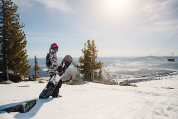 snowboarder man standing on winter mountain top