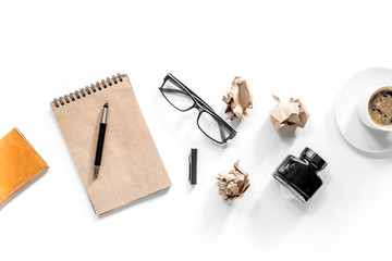 Writer concept. Vintage notebook, crumpled paper and glasses on white background top view