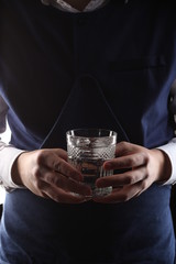 Glass of water in mans hands