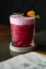 Cherry cocktail on black table. Close up