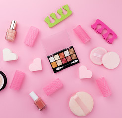 Beauty Spa Feminine Concept. Different Make Up Beauty Care Essentials Cosmetics on Flat Lay Pink Background. Top View. Above.