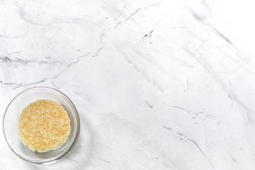 paella home cooking with rice for ingredients on white background top view space for text