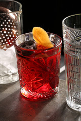 Negroni in the middle of three glasses. Close up