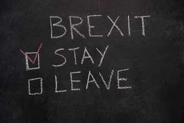 Fototapeta na wymiar Brexit stay or leave written with white chalk on blackboard