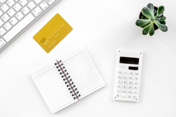 online purchasing with credit cards and notebook white manager desk background top view mock-up