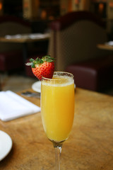 Single mimosa cocktail glass, above, vertical