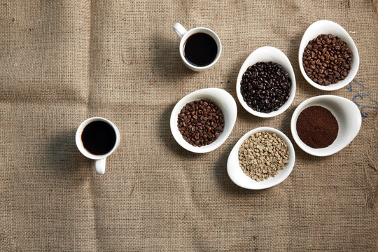 Coffee beans and black coffee in cups