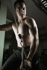 Fototapeta na wymiar Young man training at gym 