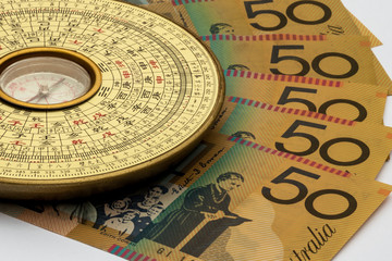 Chinese Feng Shui compass on top of Australian Money