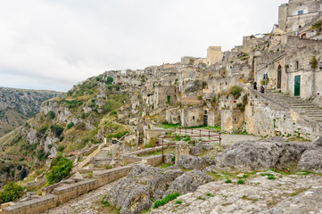 Fototapeta na wymiar The cave-town Sasso Caveoso at the edge of La Gravina - Matera, Basilicata, Italy