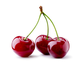 Three cherries berries on branch  close-up isolated on white background
