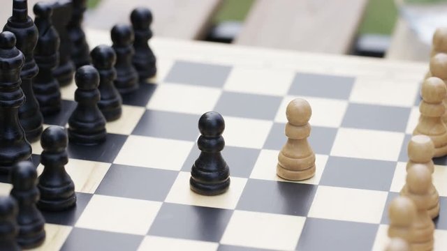 Close up shot of a game of chess being started
