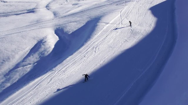 Aerial shot of snowboarder riding in powder snow