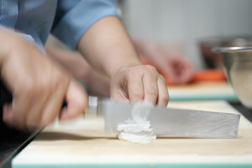Fototapeta na wymiar Chef cut vegetable on cutting board with knife japan
