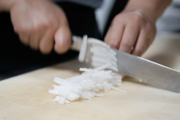 Obraz na płótnie Canvas Chef cut vegetable on cutting board with knife japan