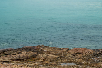 Rocks on the beach and blue sea