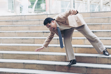 Businessman falling down the steps of staircase © palidachan