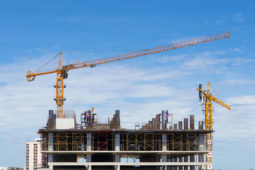 construction crane and worker of building industry with blue sky