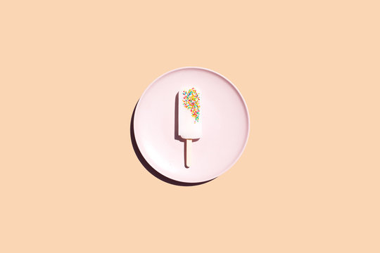 Summer popsicle on plate, bright background 