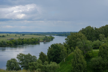 Summer landscape with views of the river from the high Bank