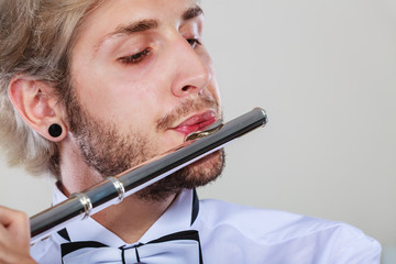 Male flutist playing his flute closeup © anetlanda