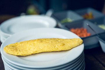 Selective focus Omelet on plate with blur cooking background and effect filter.