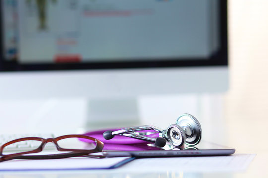 Stethoscope with a tablet computer lie on a table